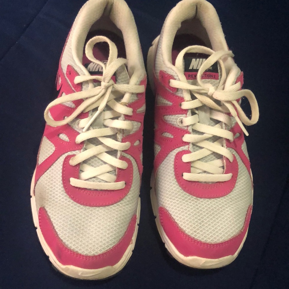 Pink and white Nike’s with black swoosh.